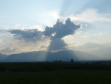 Sun behind Towering Cloud