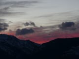 Crimson Glow behind Silver Clouds