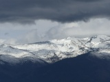 Clouds over Snow Covered Mountains