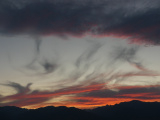 Gray Wisps Between Sunset Colors