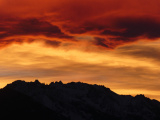 Orange Clouds over Jagged Peaks