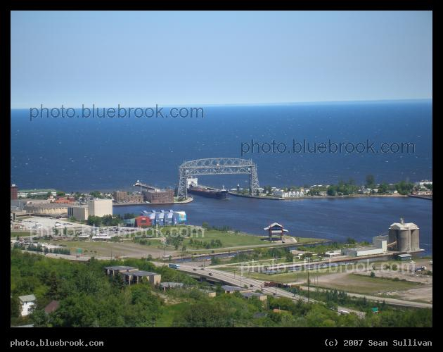 Duluth Lift Bridge - A ship passing under the lift bridge in Duluth MN, with Lake Superior in the background