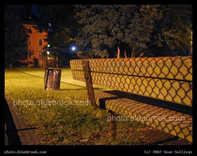 Chain Link Shadow - The shadow of a chain-link fence falling on a park bench, Brookline MA