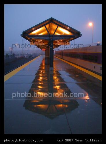 Canopy at Dusk - After a rain shower, a canopy at the MBTA Newburyport train station is reflected by the wet platform