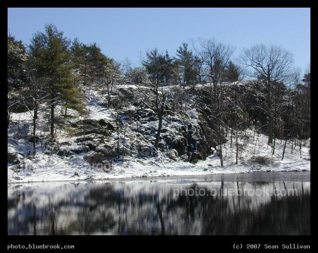 Winter Hillside - A snowy hillside reflected in a lake at Pine Banks park, Malden/Melrose MA