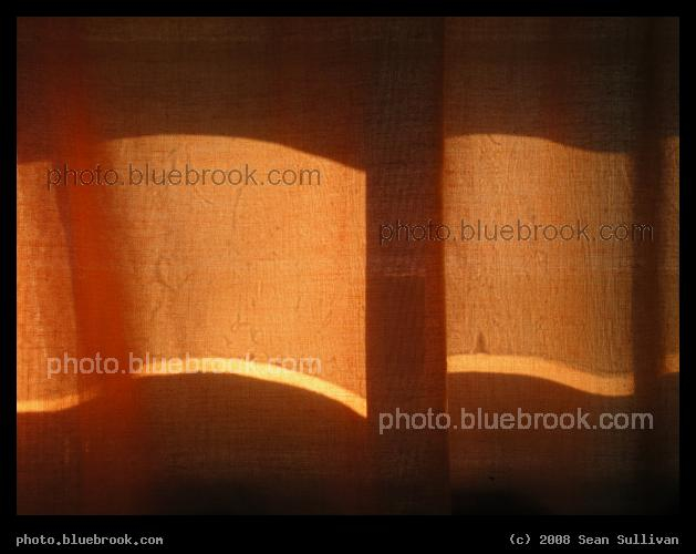 Swash of Orange - Sunlight shining through orange curtains