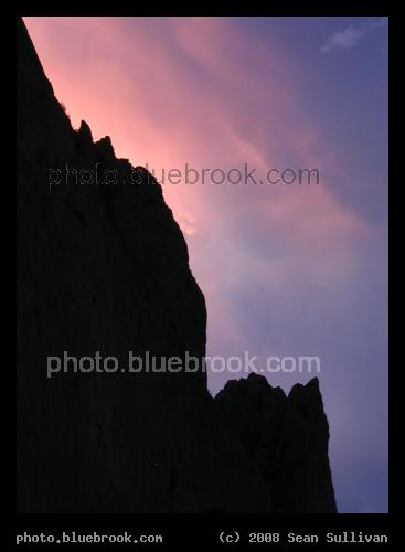 Margin - Rosy clouds glowing behind a rock face at the Garden of the Gods, Colorado Springs CO