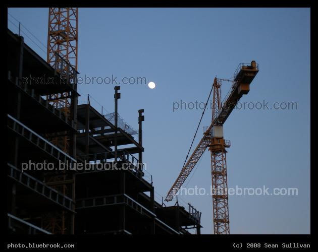 Construction - Cranes and the moon above a building under construction.  Located on Causeway Street, Boston MA