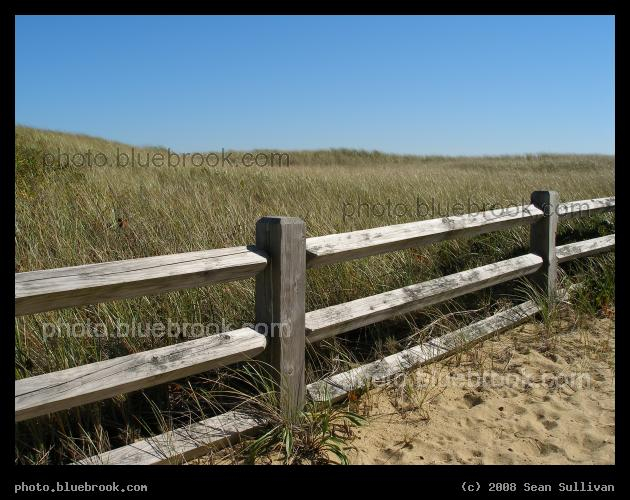 Beyond the Beach - A fence between the beach and an inland field of grass, South Cape Beach State Park, Mashpee MA