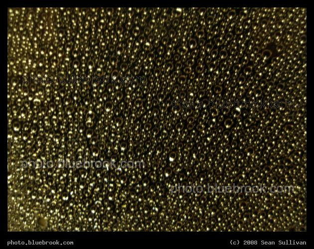 Galaxy of Droplets - Droplets of water, seen at night, on the window of a MBTA commuter rail train