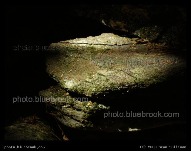 Illuminated Ledge - A sunbeam hits a rock in a shaded stone wall, western Massachusetts