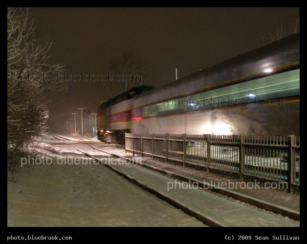 Night Train - An outbound MBTA Commuter Rail train departing West Concord station in light snow, Concord MA