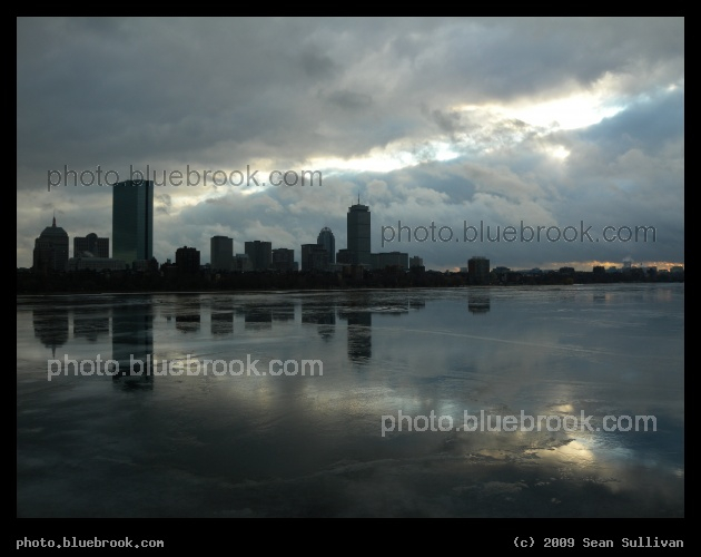 A Crack in the Sky - The Back Bay district over the melting Charles River, Boston MA