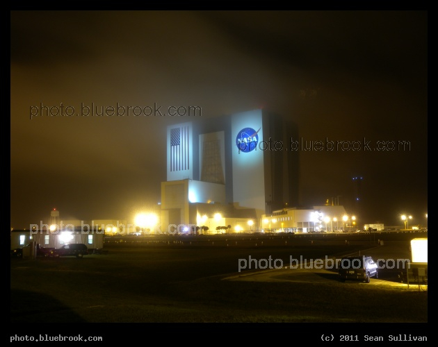 Fog over the VAB - A foggy evening at the Kennedy Space Center press site parking lot, with the Vehicle Assembly Building in the background