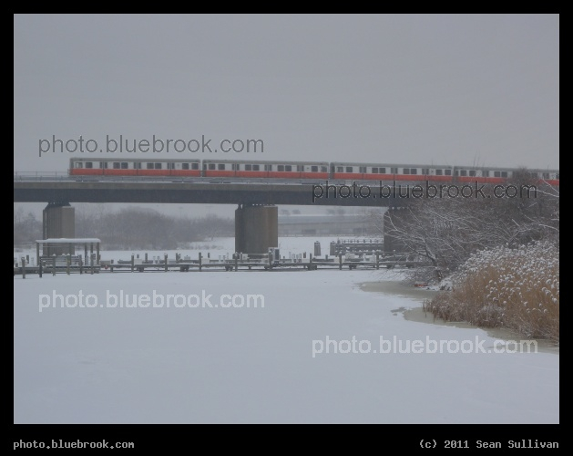 Winter Train - An Orange Line MBTA passenger train crossing the Mystic River, Somerville MA