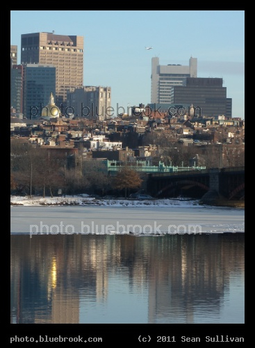 Beacon Hill, Charles River - The Boston skyline, including the Massachusetts State House (gold dome) and MBTA Charles/MGH subway station (green structure at the base of the Longfellow Bridge), visible across the Charles River