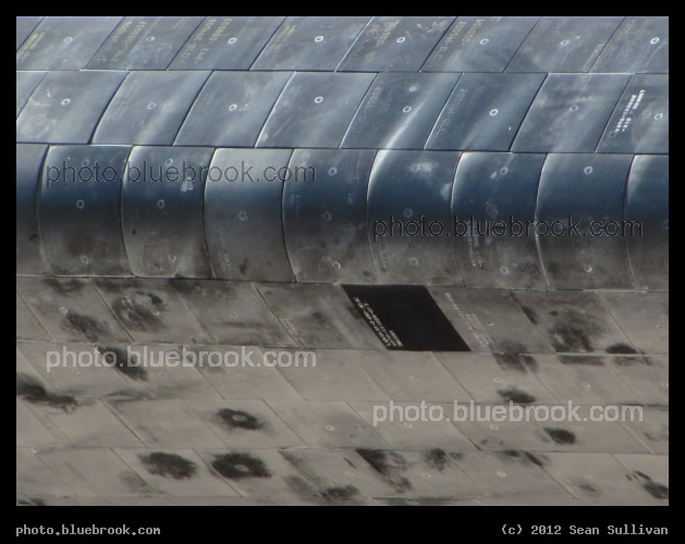 Tiles in Daylight - Close-up view of tiles on the edge of the left wing of space shuttle Atlantis, seen during the rollover to the VAB for STS-135, the final flight of the shuttle program.