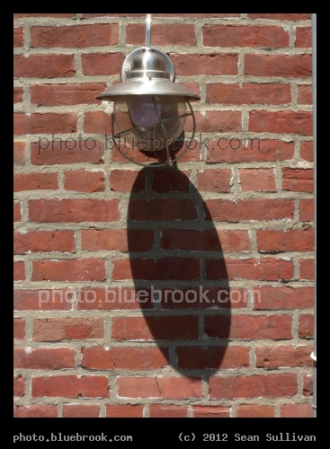 Oval on Rectangles - The shadow of a patio lamp on a brick wall, Boston MA