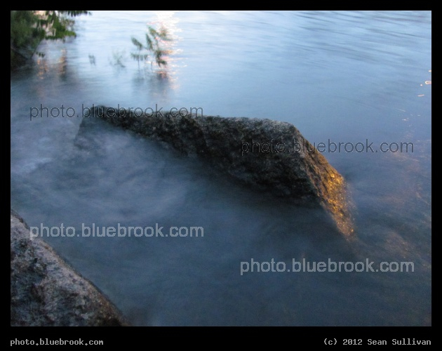 Blurred Wave - During this 1 second exposure in evening twilight, waves on the Charles River from a passing boat were rising and falling against this rock on the Allston MA shoreline