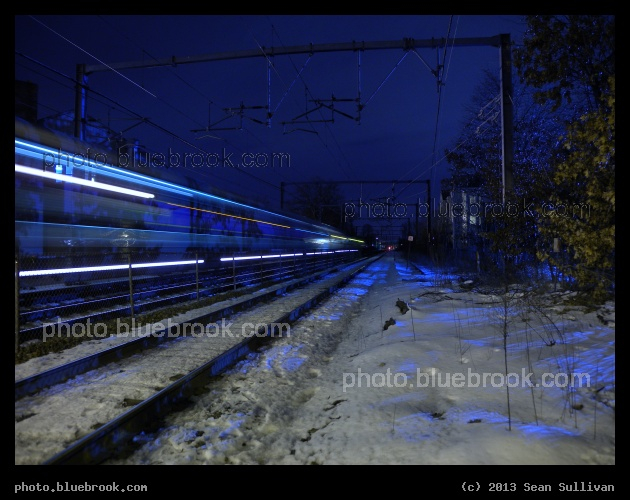 Electric Blue - A time-lapse image of a passenger train on the Northeast Corridor, south of MBTA Hyde Park station, Boston MA