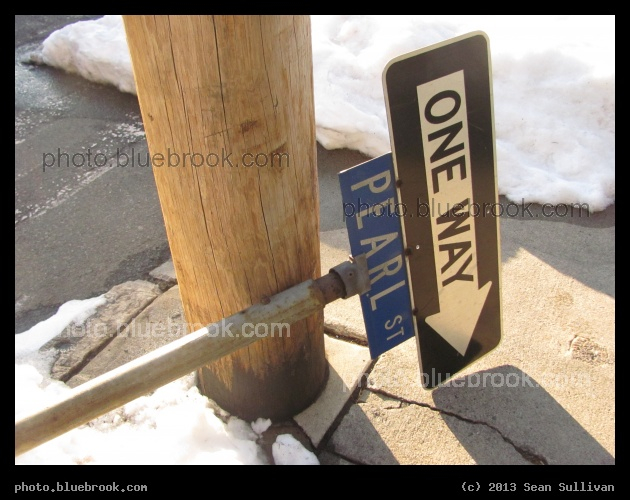 After the Blizzard - A streetsign felled by a snowpile on the side of the road, Somerville MA
