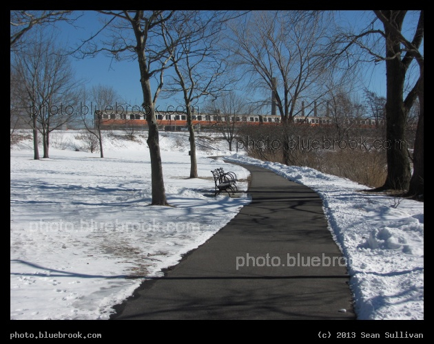 Winter Walk - An Orange Line MBTA subway train along the Mystic River Reservation, Medford MA