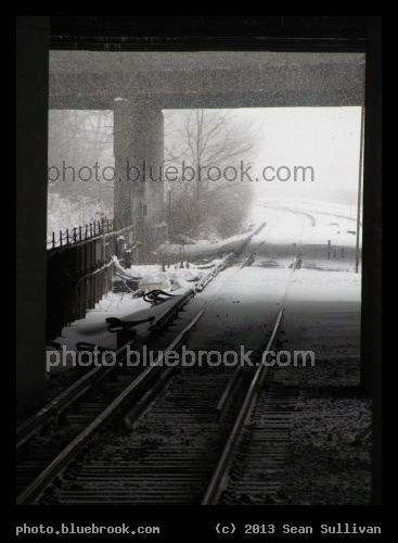 Bridge Shadows - During a snowstorm, MBTA Orange Line subway tracks passing under highway bridges, Boston MA