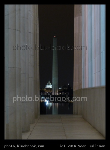 Washington Monument at Night - Washington Monument seen through a walkway on the edge of the Lincoln Monument, Washington DC